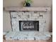 Stone fireplace with a wooden mantel creating a cozy focal point at 19 Magnolia Ne Ct, Rydal, GA 30171