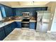 Kitchen with stainless steel appliances, blue cabinets, and butcher block countertops at 19 Magnolia Ne Ct, Rydal, GA 30171