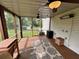 Inviting screened porch with ceiling fans, space heater, and black and white area rug at 19 Magnolia Ne Ct, Rydal, GA 30171