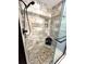 Shower stall featuring pebble flooring, built in shelves and sleek shower head at 19 Magnolia Ne Ct, Rydal, GA 30171