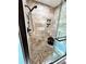 Detailed view of shower boasting tile walls, pebble flooring, and modern fixtures at 19 Magnolia Ne Ct, Rydal, GA 30171