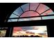 Vibrant sunset through arched window with clear and pink skies at 19 Magnolia Ne Ct, Rydal, GA 30171