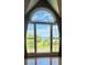 Large window with an arched top boasting scenic views of nature at 19 Magnolia Ne Ct, Rydal, GA 30171