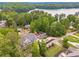 Aerial view of a gray home surrounded by large trees near the lake at 2555 Chattahoochee Ln, Cumming, GA 30041