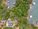 Aerial view of a wooded neighborhood and the nearby lakefront docks at 2555 Chattahoochee Ln, Cumming, GA 30041