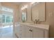 Well-lit bathroom featuring a double vanity, decorative mirrors, and modern fixtures at 2555 Chattahoochee Ln, Cumming, GA 30041