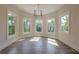 Bedroom sitting area with bay window featuring leafy tree views and modern chandelier at 2555 Chattahoochee Ln, Cumming, GA 30041