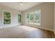 Light-filled bedroom with hardwood floors, offering peaceful views and ample space at 2555 Chattahoochee Ln, Cumming, GA 30041