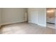 Spacious bedroom features hardwood floors, light gray walls, and an ensuite bathroom for modern comfort and convenience at 2555 Chattahoochee Ln, Cumming, GA 30041