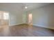Spacious primary bedroom with hardwood floors, ceiling fan, and access to an en-suite bathroom at 2555 Chattahoochee Ln, Cumming, GA 30041