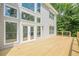 Spacious wooden deck with glass windows and white trim, perfect for outdoor entertaining at 2555 Chattahoochee Ln, Cumming, GA 30041