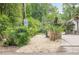 Neighborhood entrance featuring stone pillars and a lion statue, set amidst lush landscaping at 2555 Chattahoochee Ln, Cumming, GA 30041