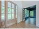 Bright foyer with wood floors, a glass front door, and views into adjacent rooms at 2555 Chattahoochee Ln, Cumming, GA 30041