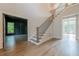 Open foyer featuring a staircase with metal railings and views into a study and living area at 2555 Chattahoochee Ln, Cumming, GA 30041
