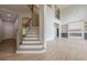 Two story foyer with staircase leading to second floor and view of fireplace and built-in shelving at 2555 Chattahoochee Ln, Cumming, GA 30041