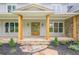 Inviting front porch with stone accents, timber columns, and a beautiful wooden door at 2555 Chattahoochee Ln, Cumming, GA 30041
