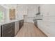 Kitchen with white cabinets, granite countertops, stainless steel appliances, and view of stone accent wall at 2555 Chattahoochee Ln, Cumming, GA 30041