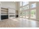 Bright living room with fireplace, built-in shelving and abundant natural light at 2555 Chattahoochee Ln, Cumming, GA 30041
