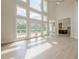 Modern living room with tall ceilings, large windows and open concept kitchen at 2555 Chattahoochee Ln, Cumming, GA 30041