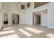 Open-concept living space with tall ceilings and access to other rooms at 2555 Chattahoochee Ln, Cumming, GA 30041