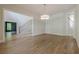 An open-concept living room with stairs, hardwood floors, and abundant natural light at 2555 Chattahoochee Ln, Cumming, GA 30041