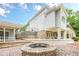 The patio features a brick fire pit and stone retaining wall perfect for outdoor entertaining at 2555 Chattahoochee Ln, Cumming, GA 30041