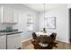 A modern dining area with a round table, brown chairs, stylish decor, and a bright window view at 4457 Watson Ridge Dr, Stone Mountain, GA 30083