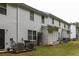 View of townhome exteriors, each unit with a small, grassy backyard and siding at 4457 Watson Ridge Dr, Stone Mountain, GA 30083