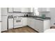 Updated kitchen with stainless steel appliances, white cabinets, granite counters, and hardwood floors at 4457 Watson Ridge Dr, Stone Mountain, GA 30083