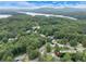 Aerial view of a home near a lake with lush greenery and rolling hills at 4934 Pickys Se Holw, Acworth, GA 30102