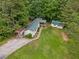 Aerial shot of a home with green metal roof, surrounded by lush trees and expansive yard at 4934 Pickys Se Holw, Acworth, GA 30102