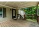 A spacious porch with a wood plank floor and a view to the woods at 4934 Pickys Se Holw, Acworth, GA 30102