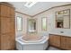 Bathroom features a skylight, bathtub, vanity, and cabinet space at 4934 Pickys Se Holw, Acworth, GA 30102