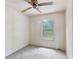 Bedroom with light walls, ceiling fan, carpeted floor, and a window view of the trees outside at 4934 Pickys Se Holw, Acworth, GA 30102