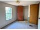 This bedroom features a large window, standard closet, carpet and neutral paint at 4934 Pickys Se Holw, Acworth, GA 30102