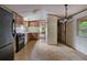 Open-concept kitchen with tile floors, wood cabinets, and access to other areas of the house at 4934 Pickys Se Holw, Acworth, GA 30102