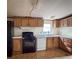 The kitchen has wooden cabinets, standard appliances, and tile flooring at 4934 Pickys Se Holw, Acworth, GA 30102
