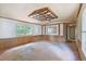 Spacious living room featuring wood paneling and ceiling fan with large windows letting in plenty of natural light at 4934 Pickys Se Holw, Acworth, GA 30102