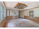Living room with wood-paneled walls, ceiling fan, and a view of the front yard at 4934 Pickys Se Holw, Acworth, GA 30102