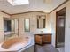 Main bathroom featuring a garden tub, skylight, vanity and walk-in shower at 4934 Pickys Se Holw, Acworth, GA 30102