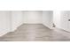 Finished basement showcasing durable, light-toned wood-look flooring and white walls, ready for customization at 809 Vinton Wood Rd, Forest Park, GA 30297