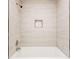 Bathroom featuring a white tub and tiled walls at 809 Vinton Wood Rd, Forest Park, GA 30297