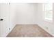 A neat bedroom with soft carpet, white walls, a double door closet, and a sunny window at 809 Vinton Wood Rd, Forest Park, GA 30297