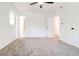A bright bedroom featuring plush carpet, fresh white walls, ceiling fan, and ample natural light at 809 Vinton Wood Rd, Forest Park, GA 30297