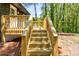 Wooden stairs leading to newly constructed deck overlooking the lush green backyard at 809 Vinton Wood Rd, Forest Park, GA 30297