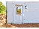 Exterior door and light fixture with a white brick wall at 809 Vinton Wood Rd, Forest Park, GA 30297