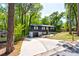 Beautiful gray house showcasing a driveway and lush green trees at 809 Vinton Wood Rd, Forest Park, GA 30297