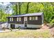 Stunning gray house with white trim, a garage, and a landscaped yard at 809 Vinton Wood Rd, Forest Park, GA 30297