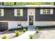 Charming home entrance with black door and manicured landscape at 809 Vinton Wood Rd, Forest Park, GA 30297