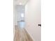 Hallway with new light wood-look flooring, neutral walls, and white trim throughout at 809 Vinton Wood Rd, Forest Park, GA 30297